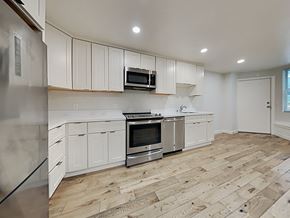 San Francisco apartment for rent - an empty kitchen with white cabinets and stainless steel appliances