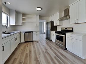 San Francisco apartment for rent - a kitchen with white cabinets and stainless steel appliances