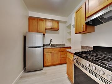 San Francisco apartment for rent - a kitchen with stainless steel appliances and wooden cabinets
