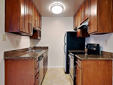 San Francisco apartment for rent - a kitchen with stainless steel appliances and wooden cabinets