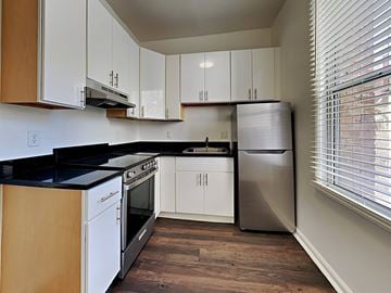 San Francisco apartment for rent - a kitchen with white cabinets and a stainless steel refrigerator