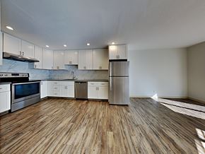 San Francisco apartment for rent - an empty kitchen with white cabinets and stainless steel appliances