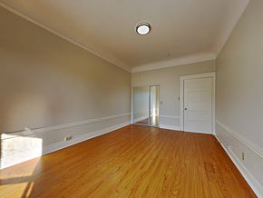 San Francisco apartment for rent - a empty living room with wood floors and a door to a closet