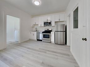 San Francisco apartment for rent - an empty kitchen with white cabinets and stainless steel appliances