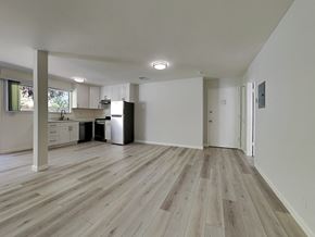Oakland apartment for rent - an empty living room and kitchen with wood floors and white walls