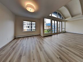 San Francisco apartment for rent - an empty living room with wood flooring and large windows