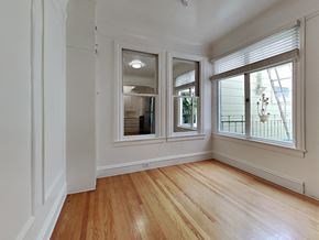 San Francisco apartment for rent - a living room with three windows and wood floors