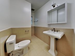 San Francisco apartment for rent - a bathroom with a toilet and a sink and a mirror