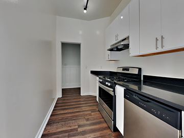 San Francisco apartment for rent - a kitchen with black counter tops and stainless steel appliances