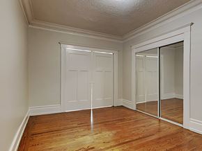 San Francisco apartment for rent - a bedroom with mirrored closet doors and a wood floor