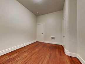 San Francisco apartment for rent - a bedroom with wood flooring and white walls