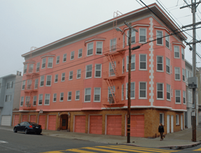 San Francisco apartment for rent - a large pink building on a city street