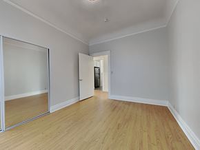 San Francisco apartment for rent - a living room with wood floors and a door to a hallway
