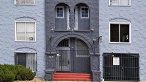 Oakland apartment for rent - a blue building with a black door and a gate