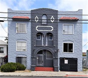 Oakland apartment for rent - a blue house with a black door and a gray building
