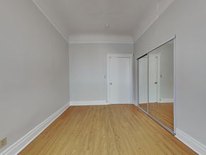San Francisco apartment for rent - a bedroom with mirrored closet doors and a hard wood floor