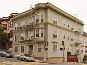 San Francisco apartment for rent - a tall building on the corner of a city street