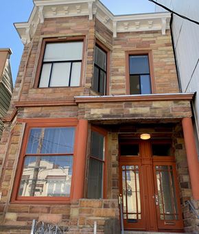 San Francisco apartment for rent - the front of a brick building with orange doors and windows