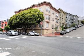 San Francisco apartment for rent - a city street with cars parked in front of a building
