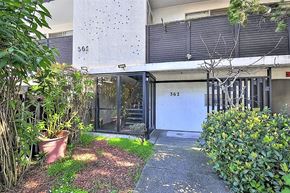 Oakland apartment for rent - the front door of a house with a yard and plants