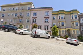 San Francisco apartment for rent - a parking lot with cars in front of a building