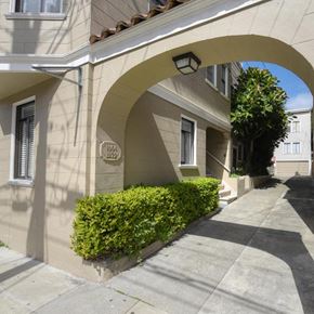 San Francisco apartment for rent - a building with an archway in front of a sidewalk