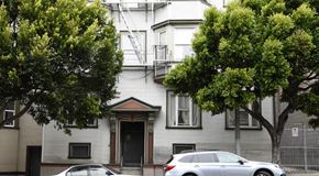 San Francisco apartment for rent - a white house with two cars parked in front of it