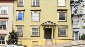 San Francisco apartment for rent - a yellow house with a car parked in front of it