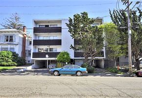 Oakland apartment for rent - a blue car parked in front of an apartment building