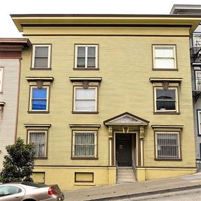 San Francisco apartment for rent - a yellow house with a car parked in front of it