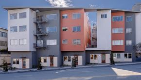 San Francisco apartment for rent - a street view of an apartment building with balconies and a road