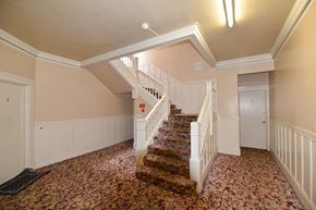 San Francisco apartment for rent - the landing of a staircase in a home with a carpeted floor