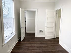 San Francisco apartment for rent - a bedroom with a hard wood floor and a door to a closet