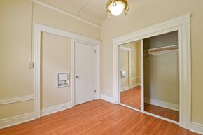 San Francisco apartment for rent - a living room with a mirror and a door to a closet