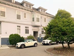 San Francisco apartment for rent - A white car is parked in front of a grey building.