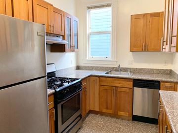 San Francisco apartment for rent - a kitchen with stainless steel appliances and wooden cabinets
