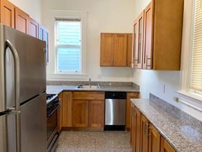 San Francisco apartment for rent - a kitchen with wooden cabinets and a stainless steel refrigerator