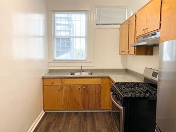 San Francisco apartment for rent - a small kitchen with a stove and a window