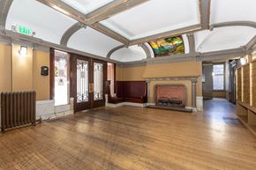 San Francisco apartment for rent - a large room with a fireplace and a stained glass ceiling
