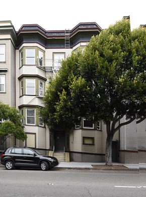 San Francisco apartment for rent - a car parked in front of a tall apartment building