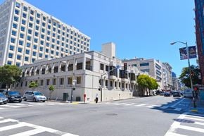 San Francisco apartment for rent - a city street with a large white building on the corner