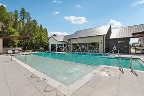 Wesley Chapel apartment for rent - A large outdoor swimming pool with a building in the background.