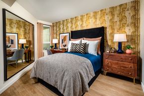 Los Angeles apartment for rent - a bedroom with a bed and a dresser and a mirror