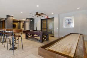 Austin apartment for rent - A room with a shuffleboard table and a pool table.