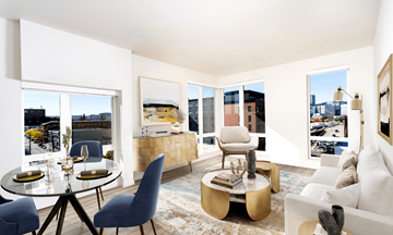 Portland apartment for rent - A modern living room with a glass table and blue chairs.