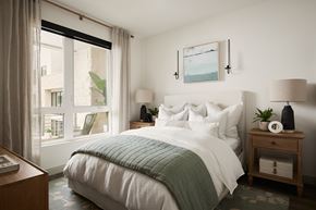 Thousand Oaks apartment for rent - A bedroom with a large bed and a window with curtains.