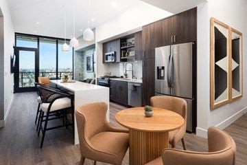 San Diego apartment for rent - A modern kitchen with a dining table and chairs.