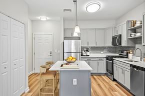 Concord apartment for rent - A kitchen with a table and chairs and a refrigerator.
