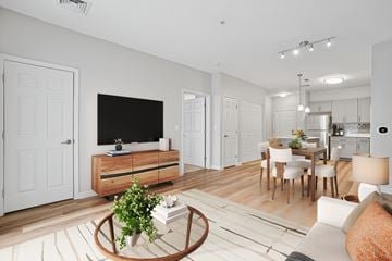Concord apartment for rent - A modern living room with a white couch and a wooden coffee table.