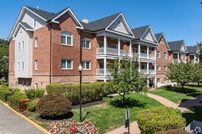 Edgewater apartment for rent - A large red brick building with a white trim and a black roof.